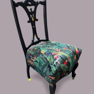 Victorian nursing chair reupholstered in Amazon jungle printed velvet and detailed with 18ct gold leaf