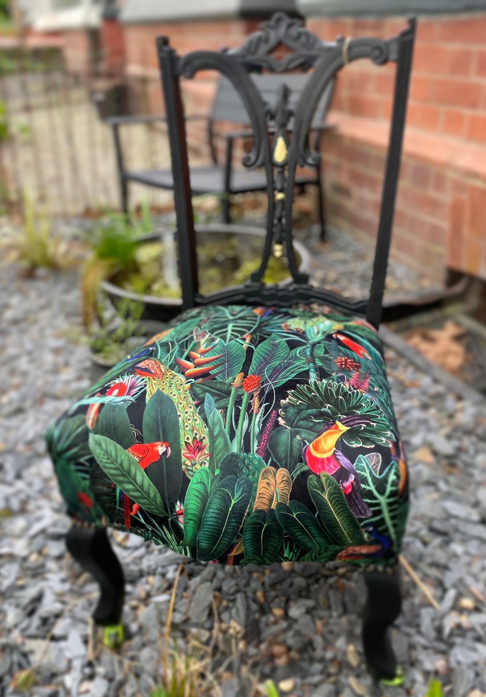 Victorian nursing chair reupholstered in Amazon jungle printed velvet and detailed with 18ct gold leaf