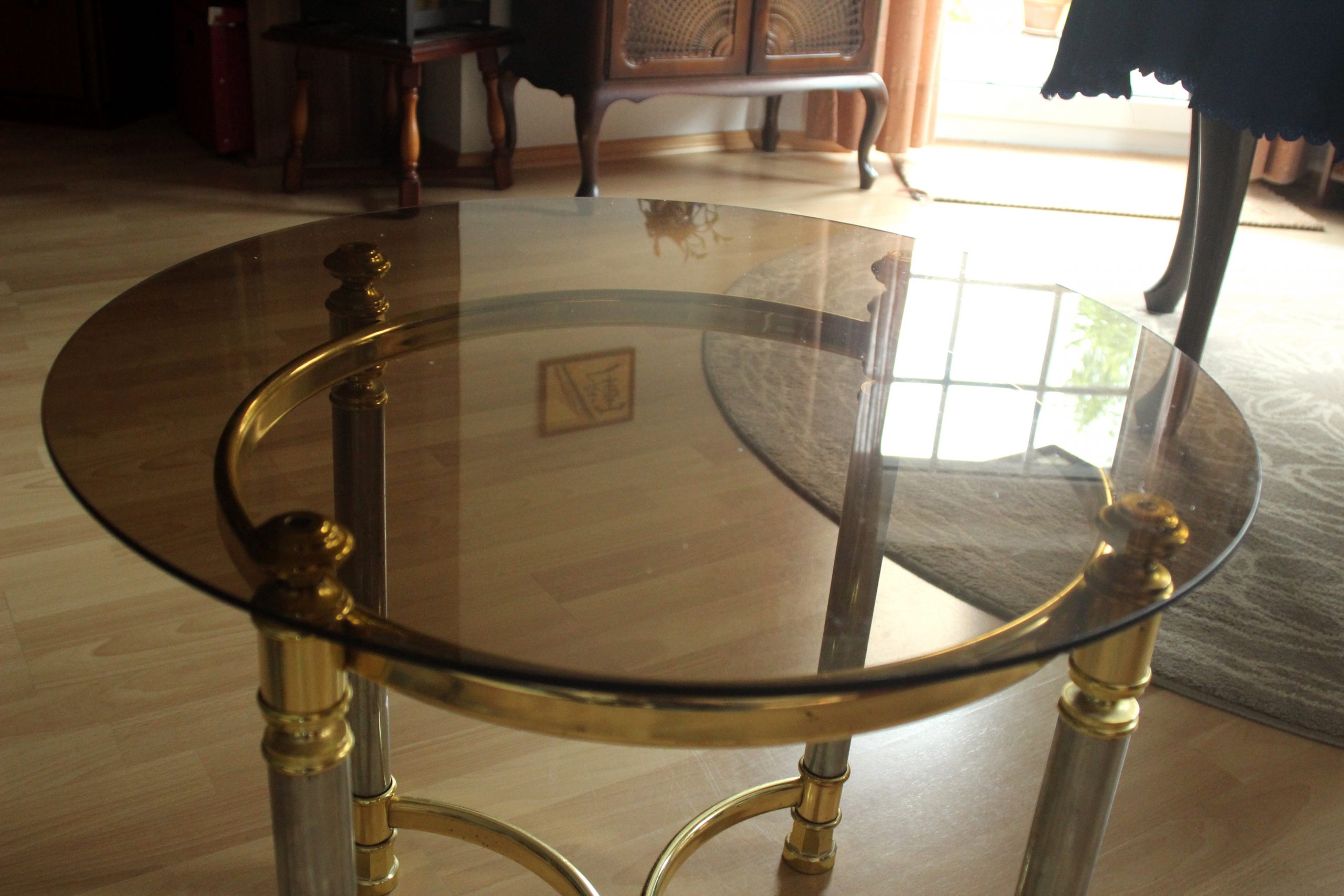 Hollywood Regency Style round coffee table, side table, made of metal with a smoked glass plate, vintage from the 1970s