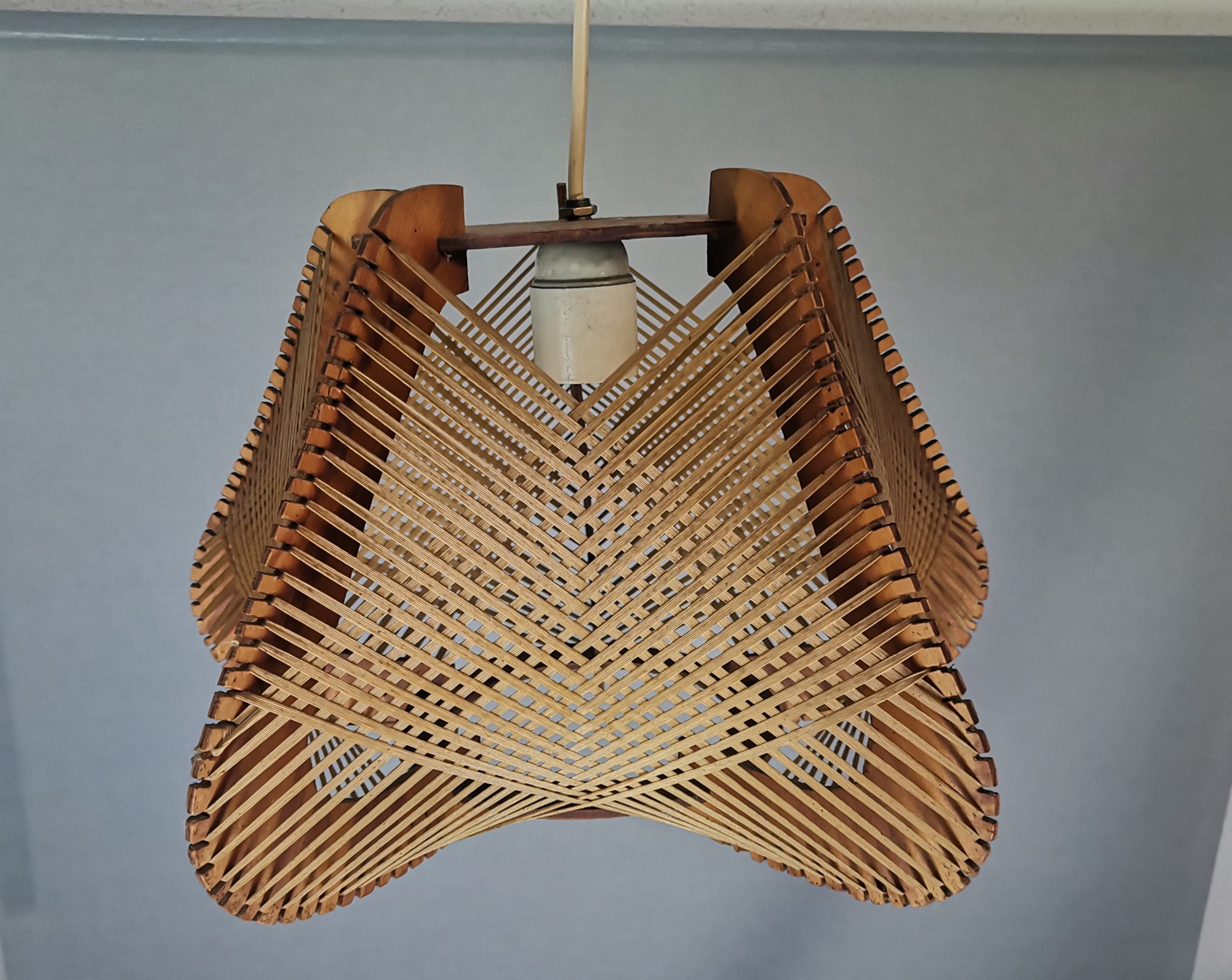 Brown plywood and straw spiderweb mid century rustic hanging lamp 1960s