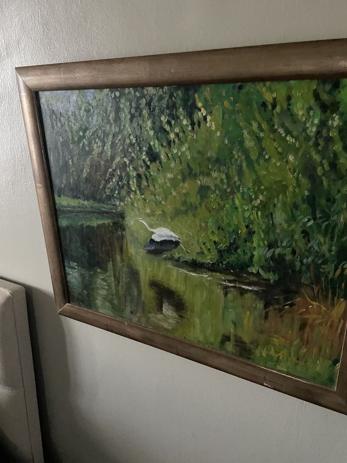 Vintage painting of a heron flying over a pond