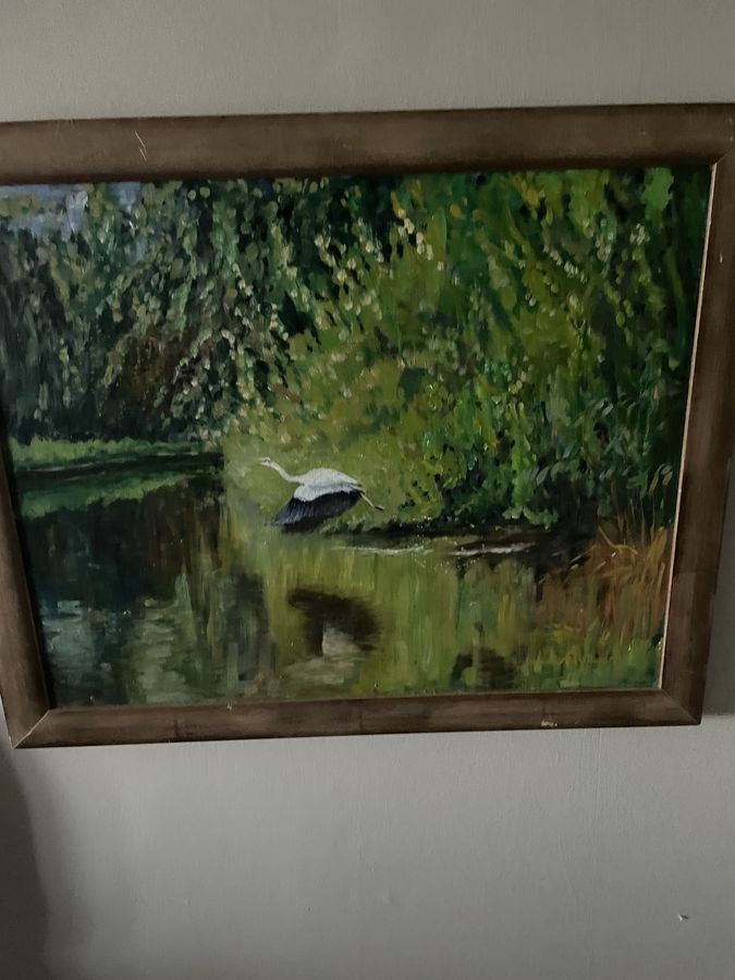 Vintage painting of a heron flying over a pond
