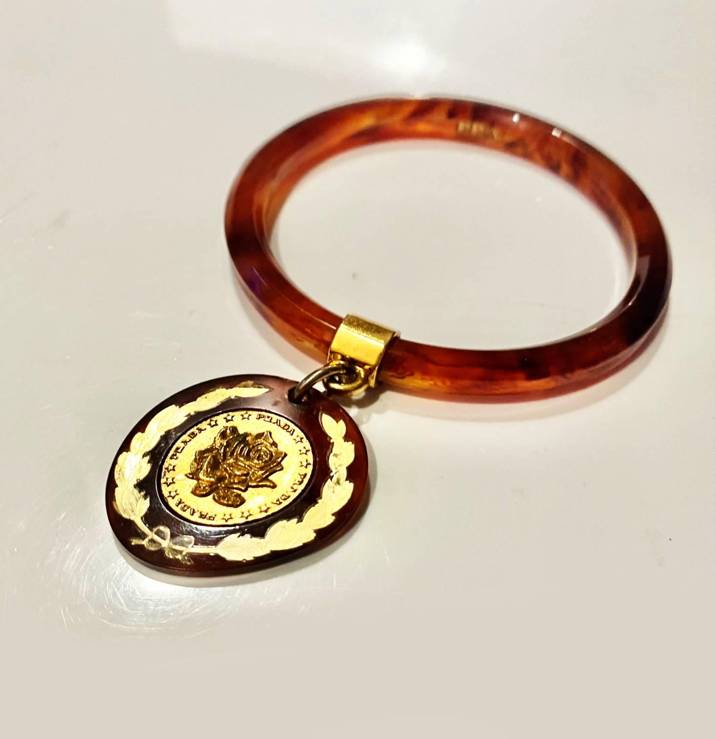 1990s Prada Resin Brown Bangle with Hanging Gold Metal Medallion