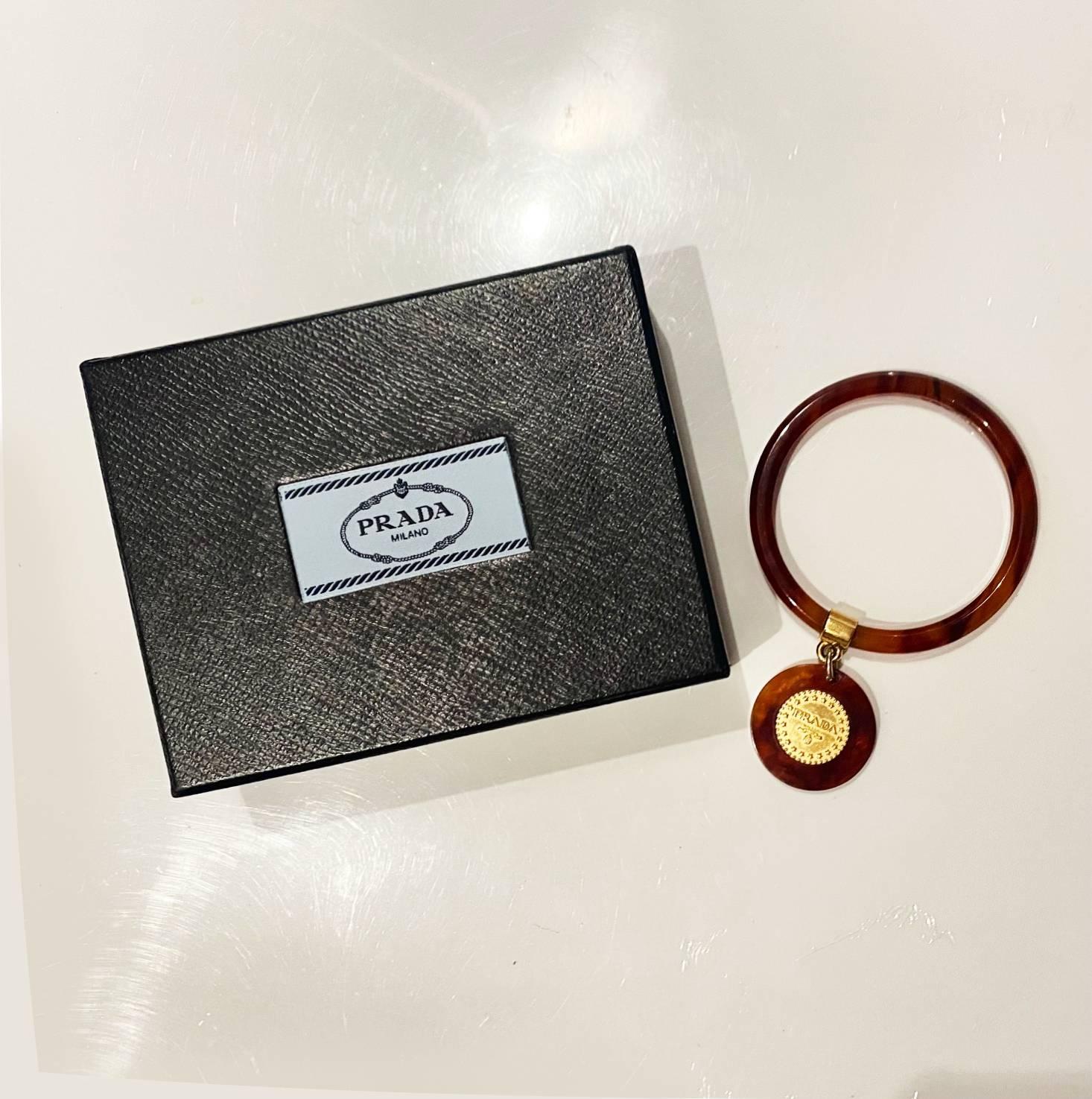 1990s Prada Resin Brown Bangle with Hanging Gold Metal Medallion