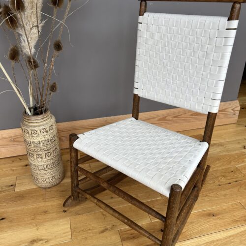 Arts and Crafts Shaker style oak rocking chair with a woven white cotton seat