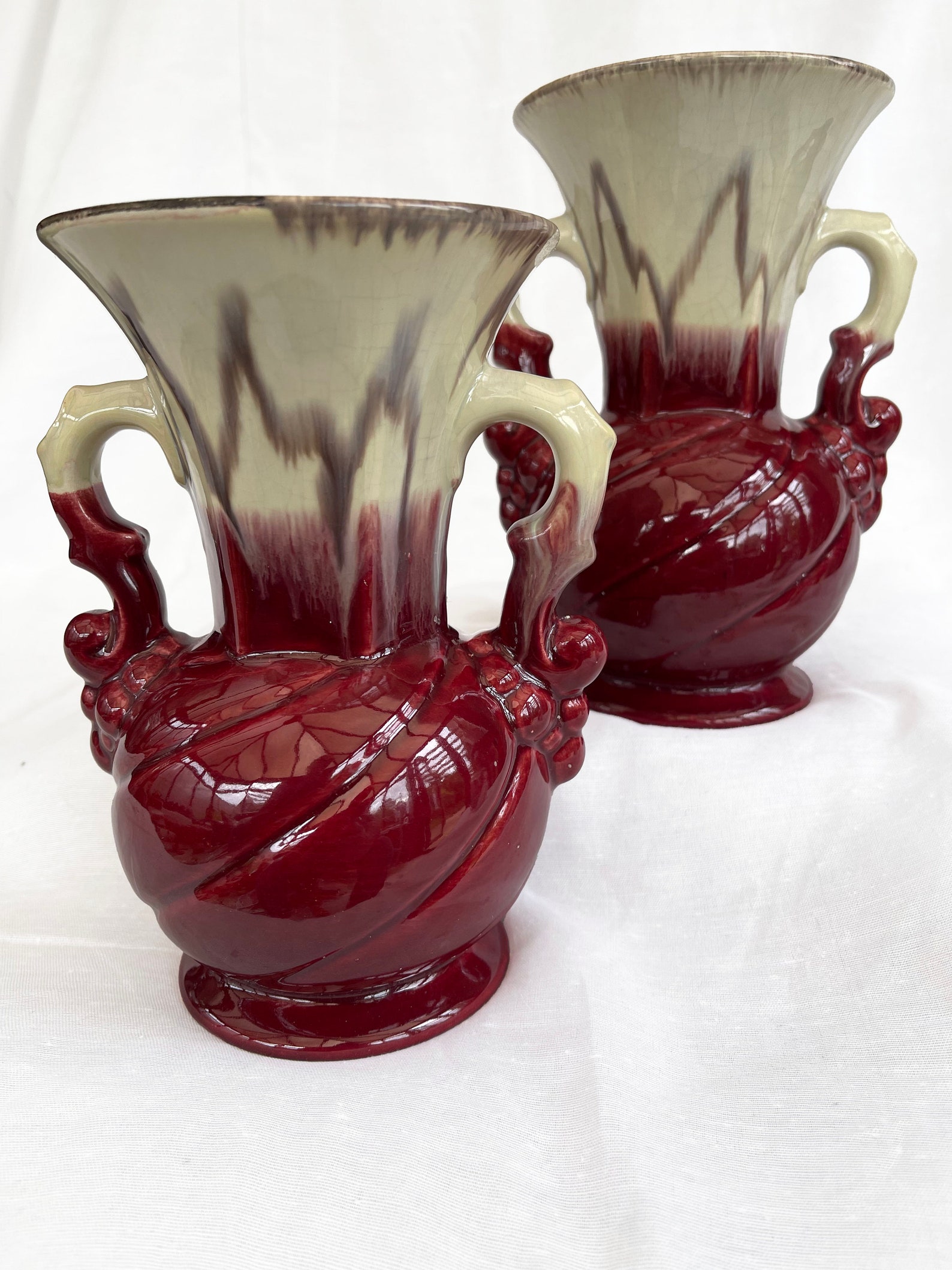 An attractive pair of Mid century fat lava glaze German handled vases