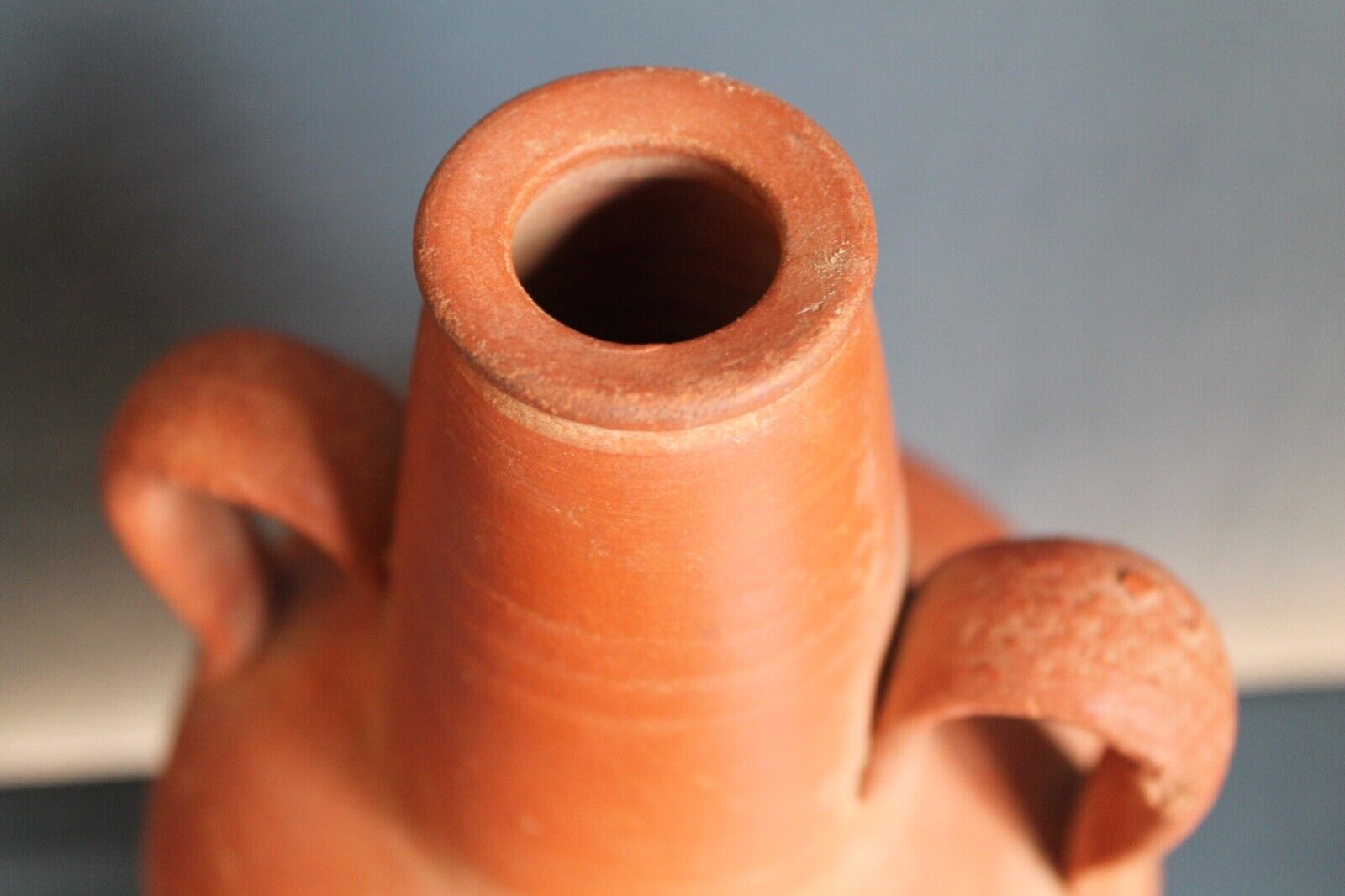 Ancient red-ware Roman amphoriskos. Antique terracotta.