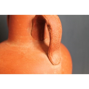 Ancient red-ware Roman amphoriskos. Antique terracotta.