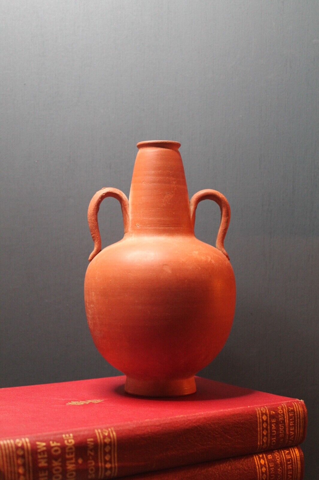 Ancient red-ware Roman amphoriskos. Antique terracotta.