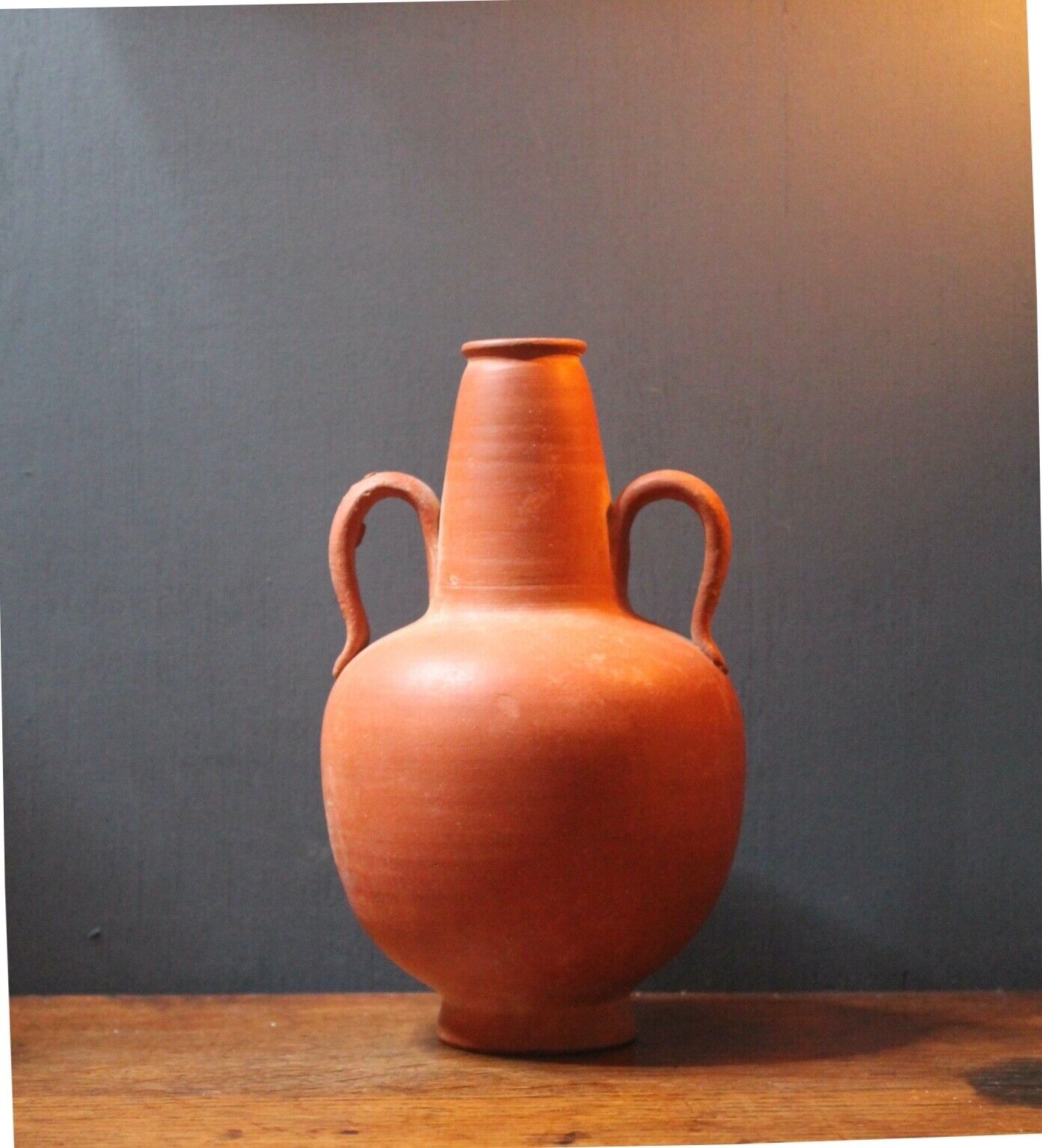 Ancient red-ware Roman amphoriskos. Antique terracotta.