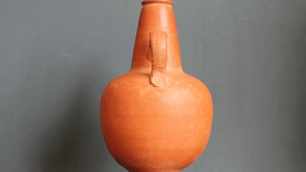 Ancient red-ware Roman amphoriskos. Antique terracotta.