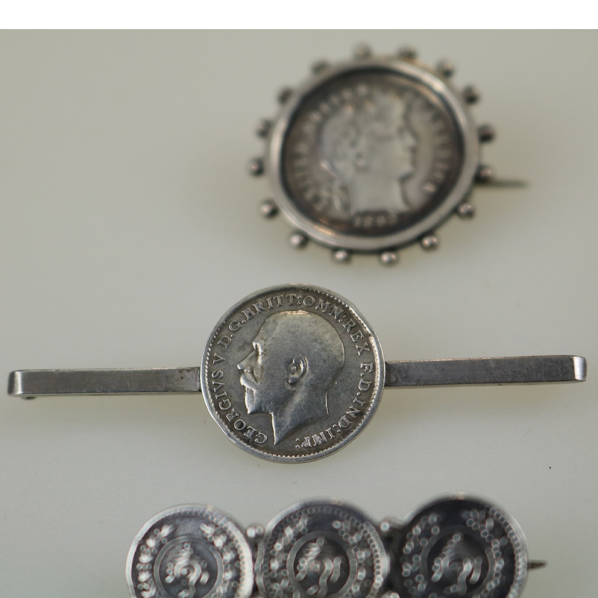 A collection of antique silver Coin Jewellery pendant & Brooches of various dates