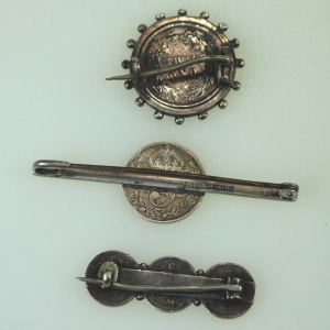 A collection of antique silver Coin Jewellery pendant & Brooches of various dates