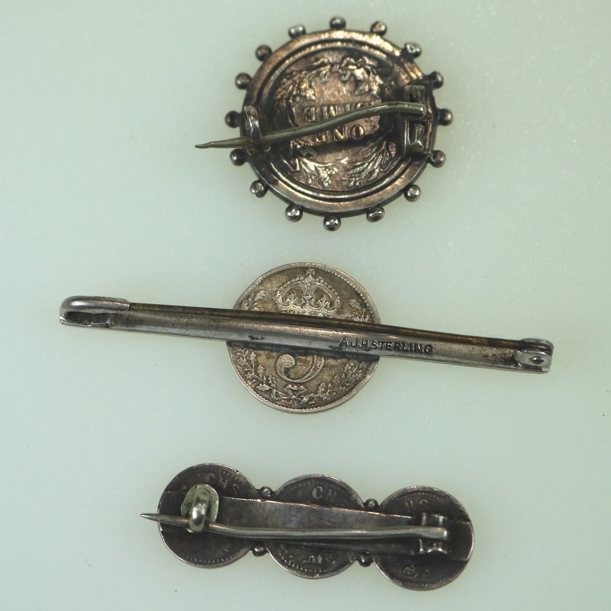 A collection of antique silver Coin Jewellery pendant & Brooches of various dates