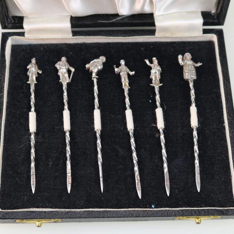 A set of novelty English solid silver Charles Dickens Characters Cocktail Sticks 1973