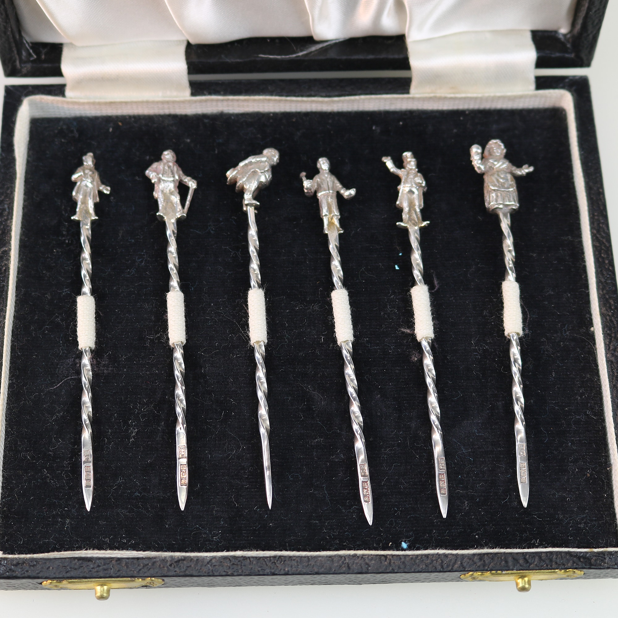 A set of novelty English solid silver Charles Dickens Characters Cocktail Sticks 1973