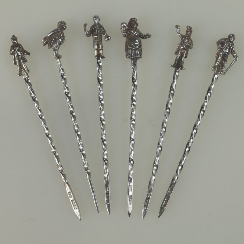 A set of novelty English solid silver Charles Dickens Characters Cocktail Sticks 1973