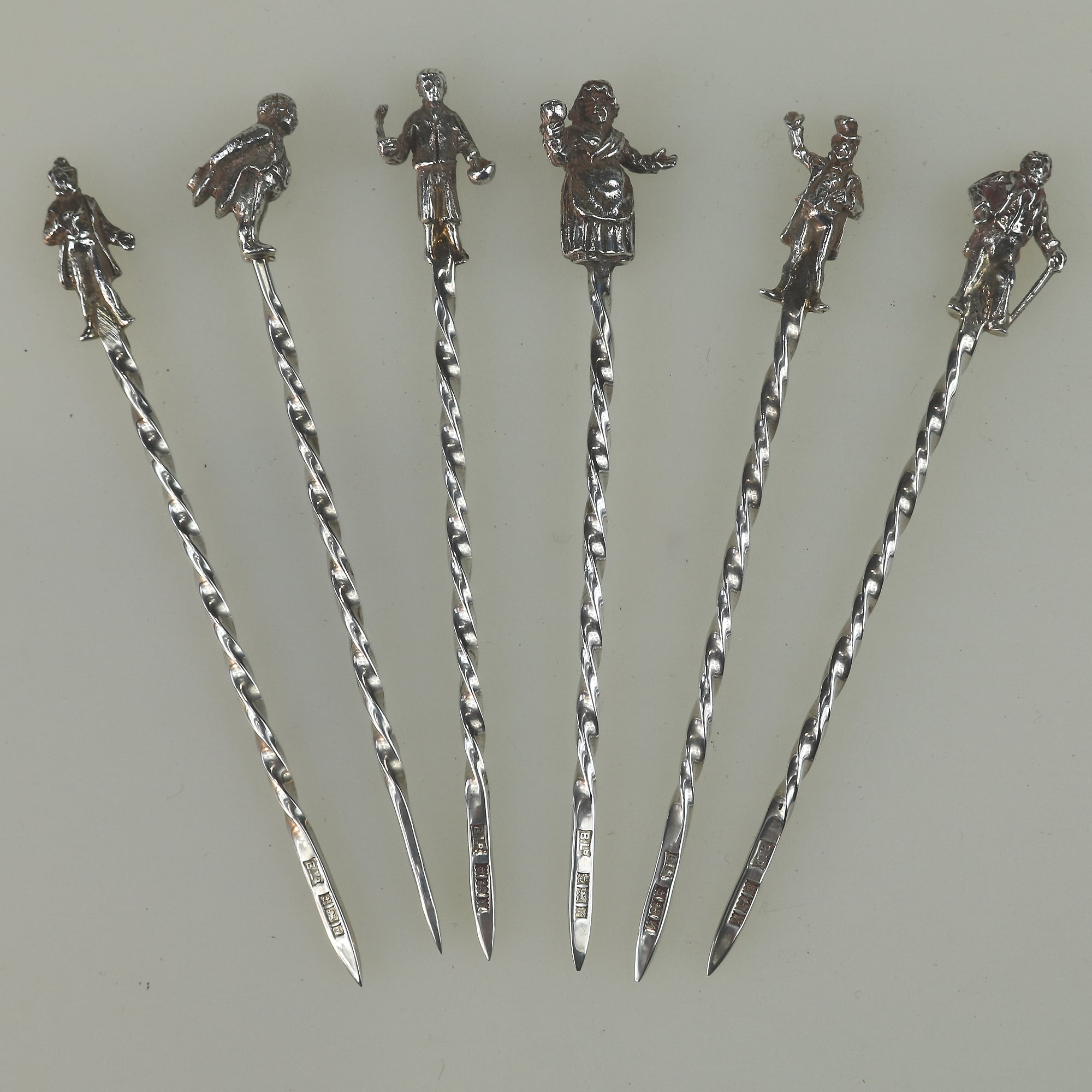 A set of novelty English solid silver Charles Dickens Characters Cocktail Sticks 1973