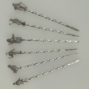 A set of novelty English solid silver Charles Dickens Characters Cocktail Sticks 1973
