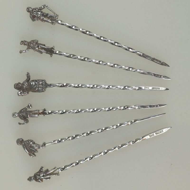 A set of novelty English solid silver Charles Dickens Characters Cocktail Sticks 1973