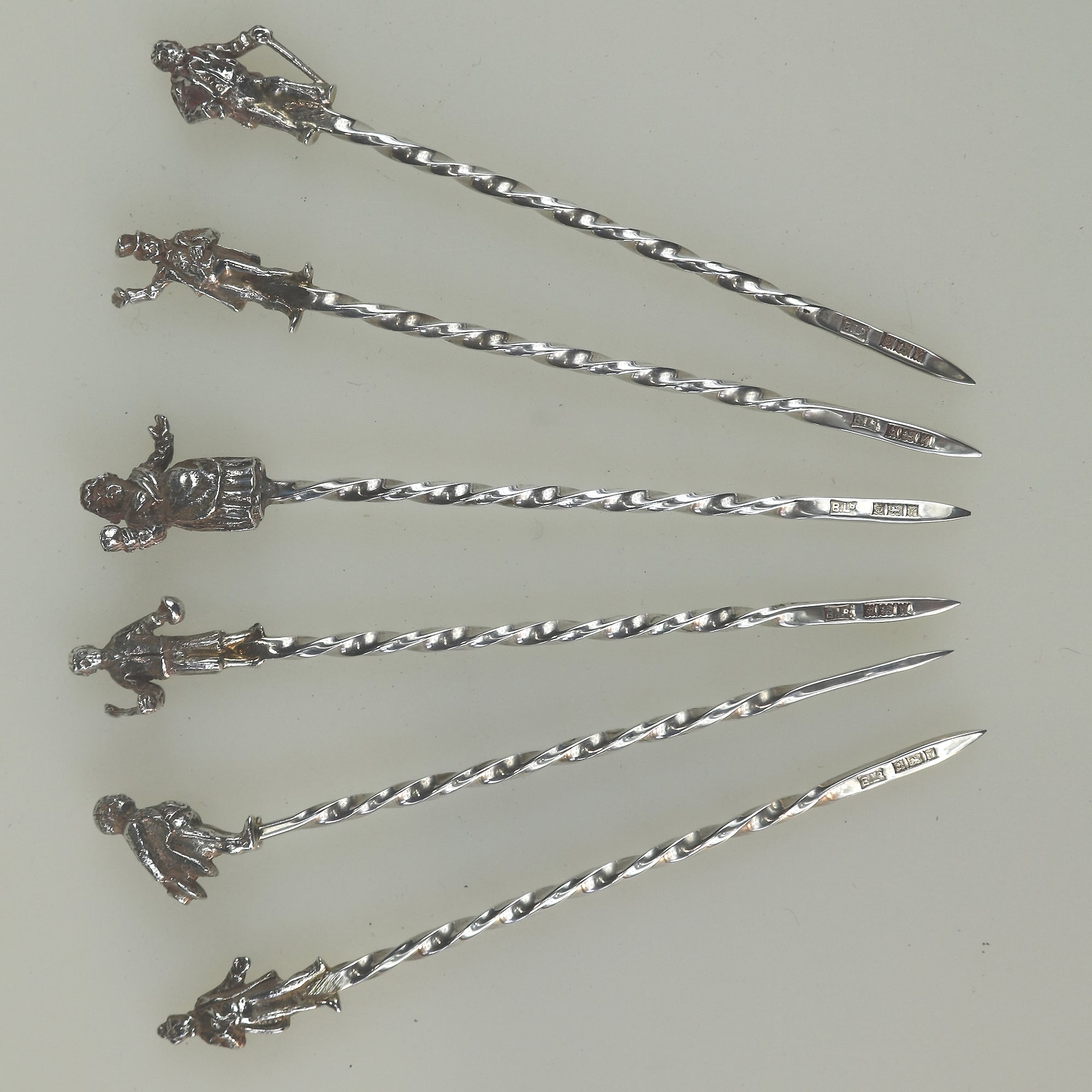 A set of novelty English solid silver Charles Dickens Characters Cocktail Sticks 1973