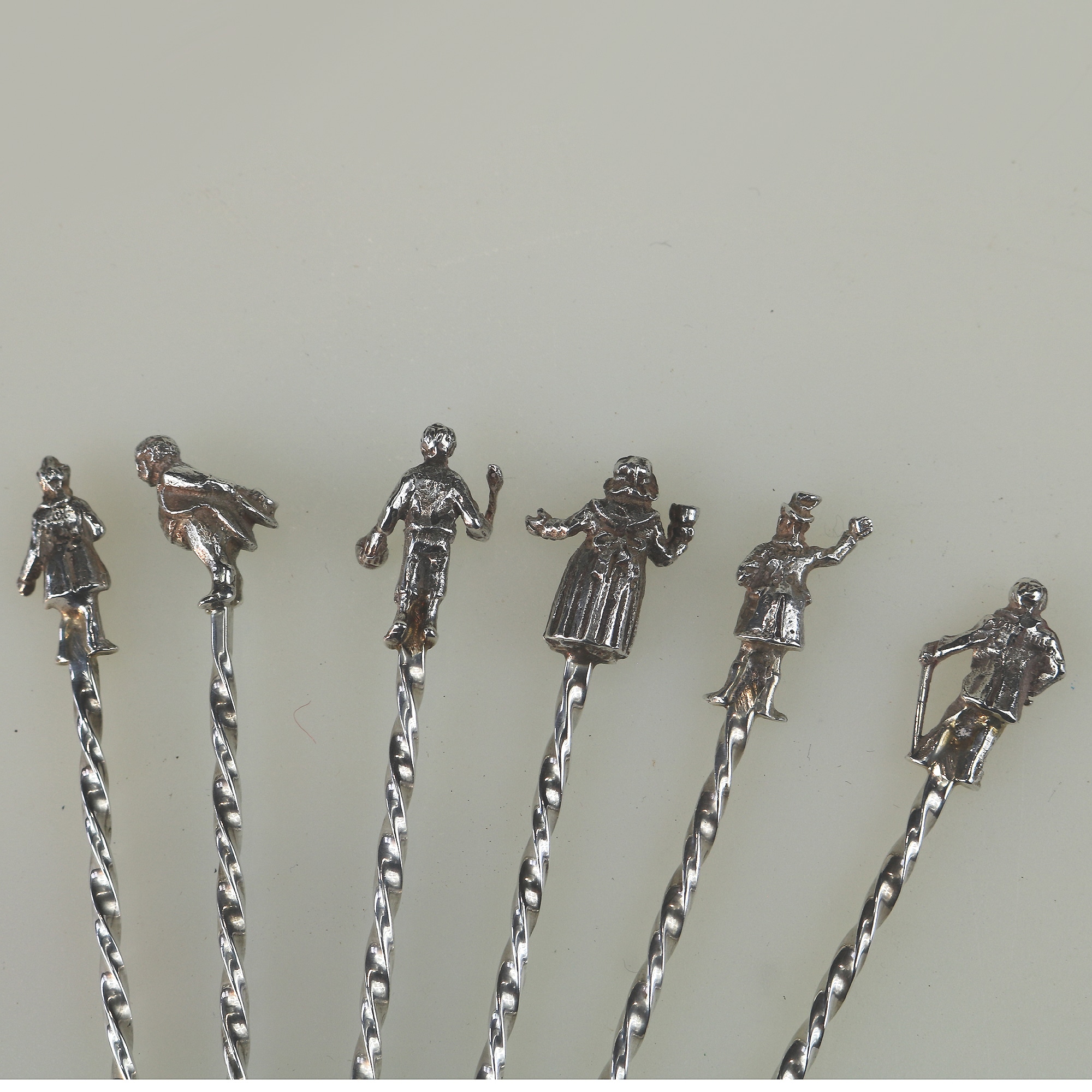 A set of novelty English solid silver Charles Dickens Characters Cocktail Sticks 1973