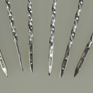 A set of novelty English solid silver Charles Dickens Characters Cocktail Sticks 1973