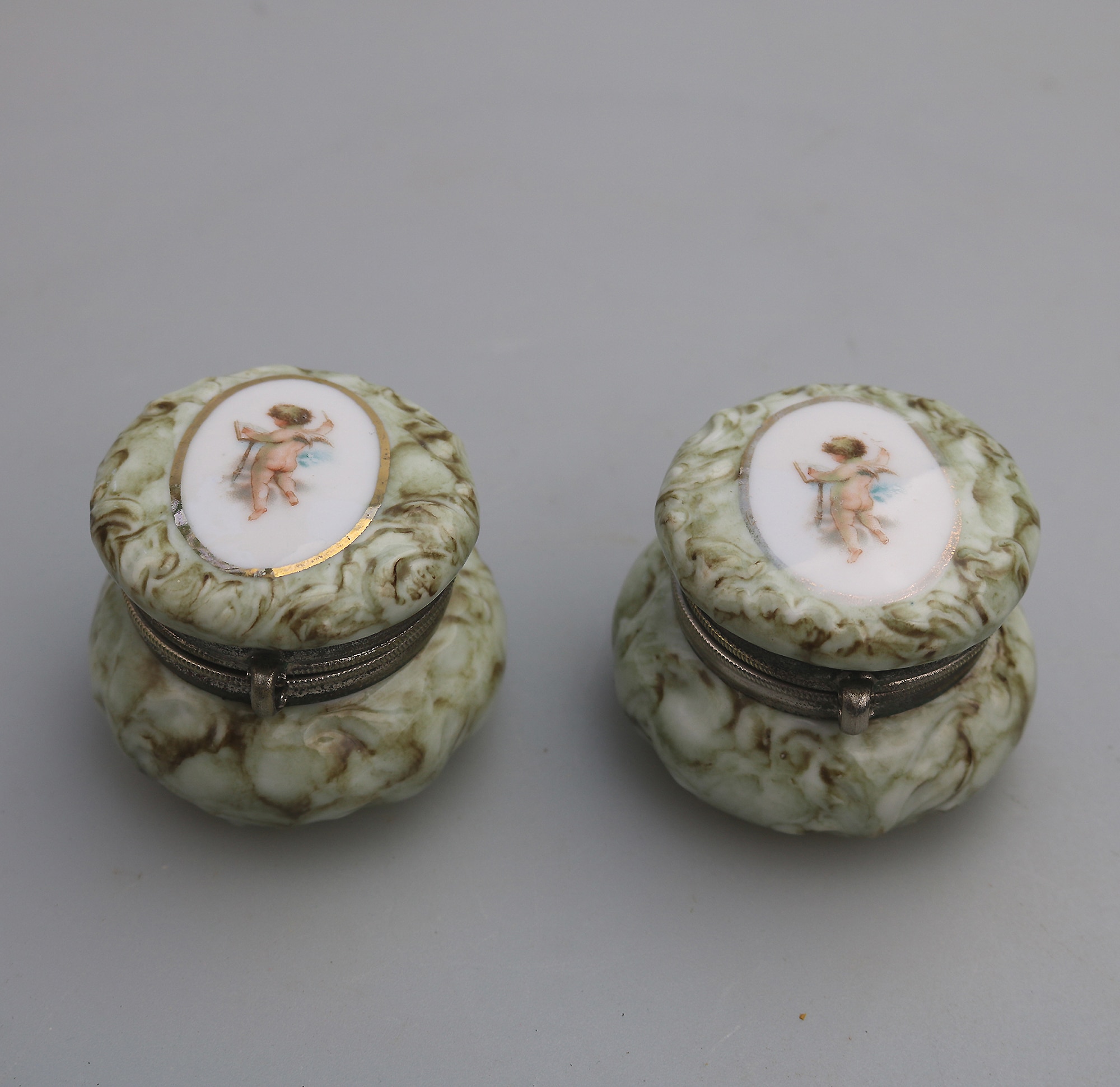 A pair of antique porcelain Continental cherub lidded Jars / Boxes C.19thC