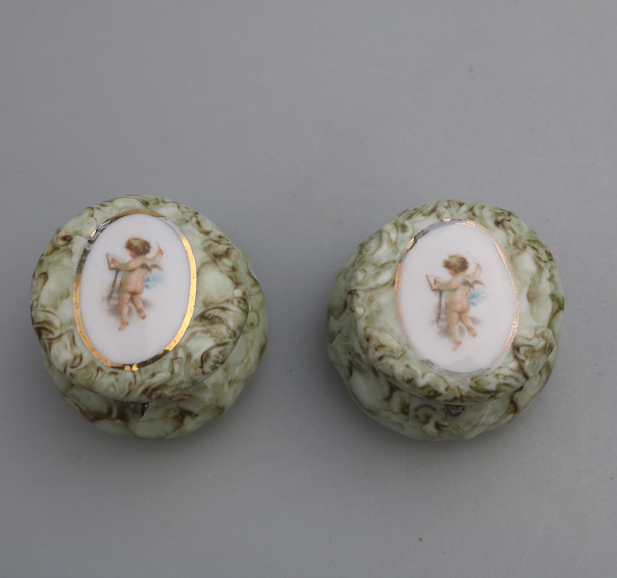 A pair of antique porcelain Continental cherub lidded Jars / Boxes C.19thC