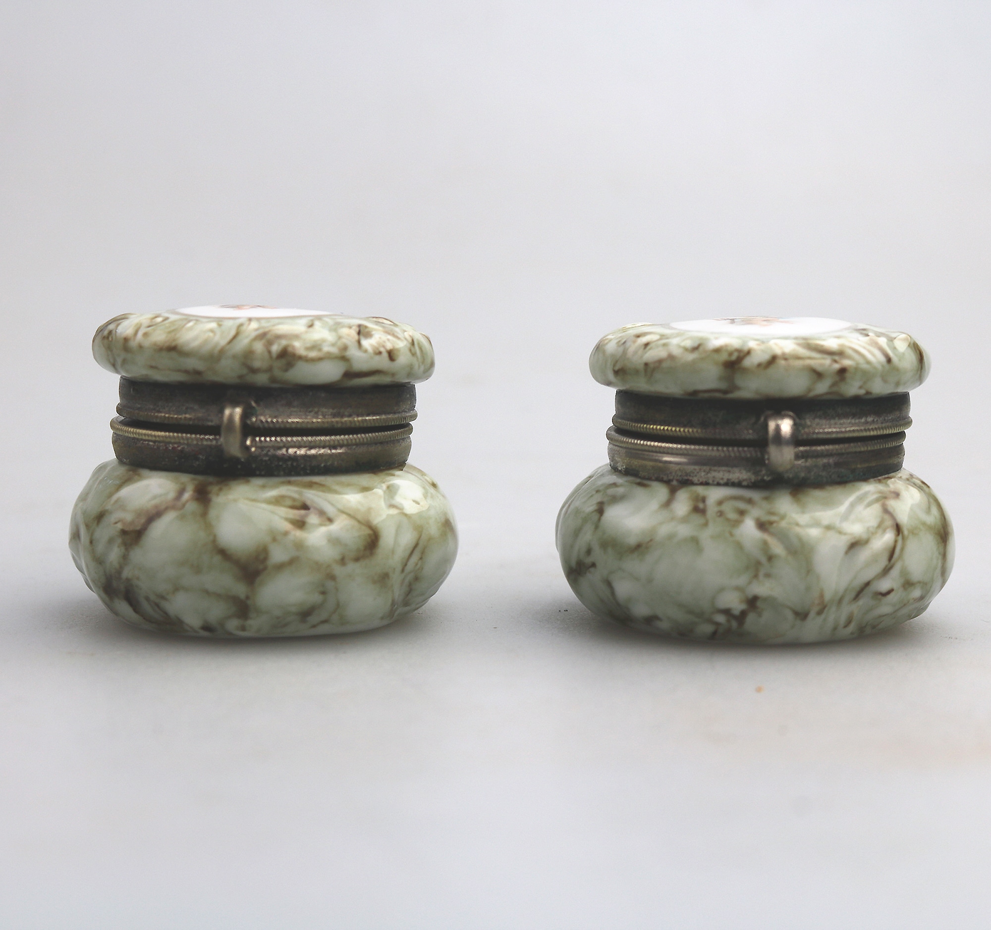 A pair of antique porcelain Continental cherub lidded Jars / Boxes C.19thC