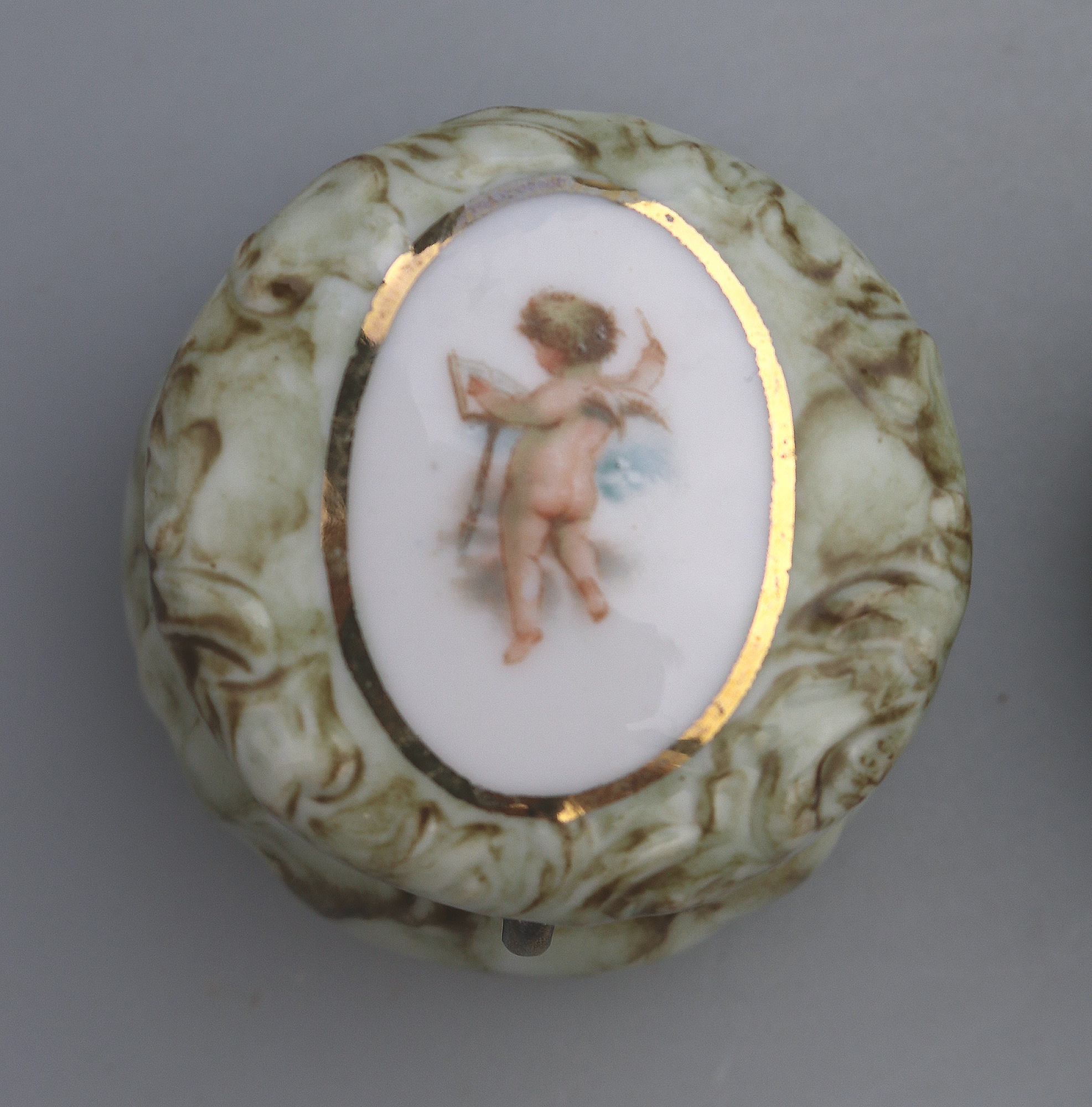 A pair of antique porcelain Continental cherub lidded Jars / Boxes C.19thC