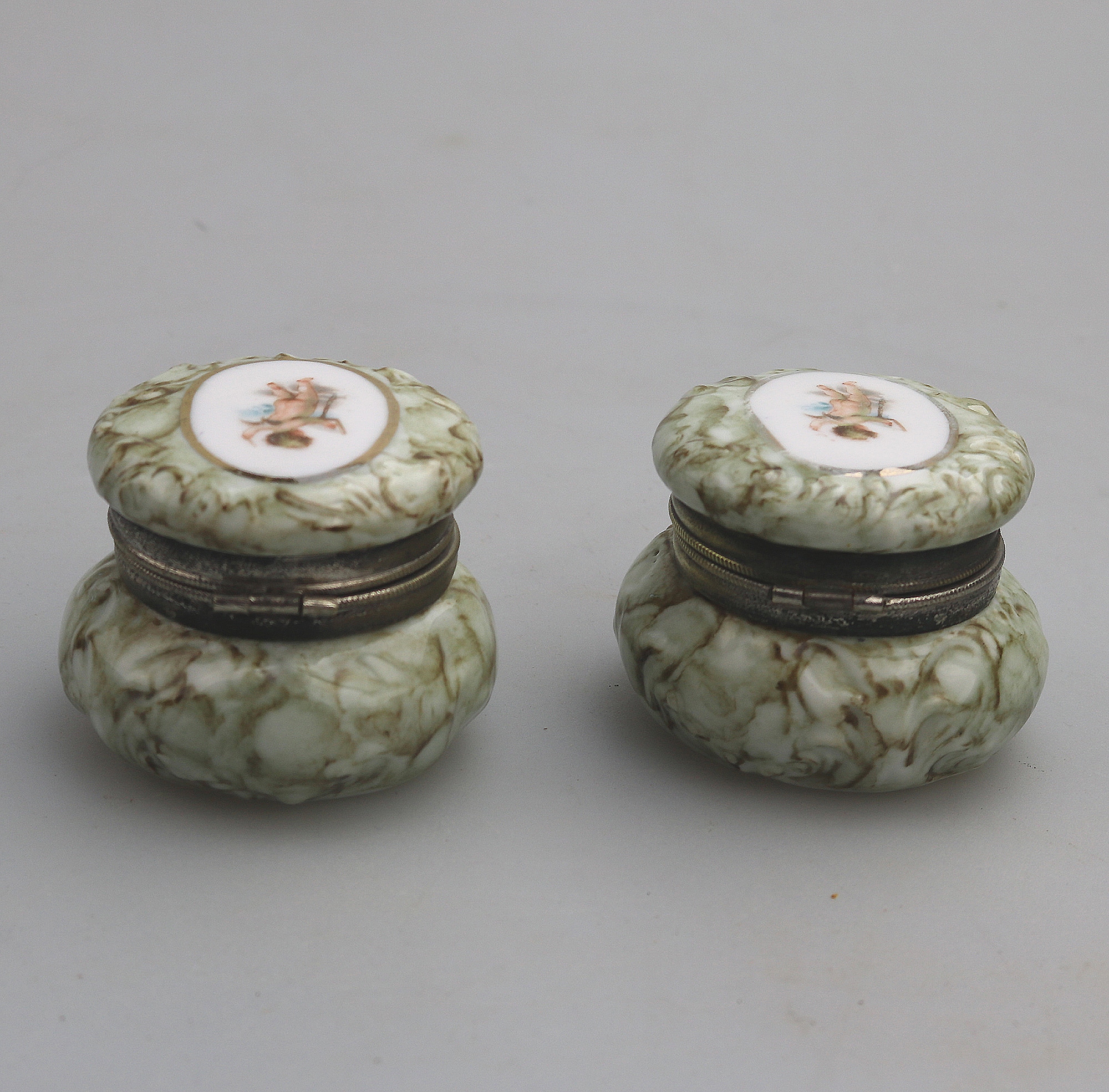 A pair of antique porcelain Continental cherub lidded Jars / Boxes C.19thC