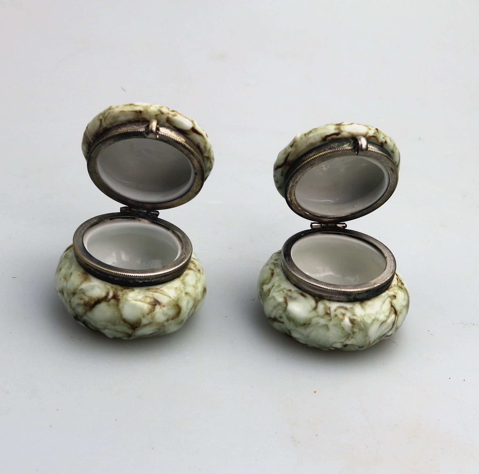 A pair of antique porcelain Continental cherub lidded Jars / Boxes C.19thC