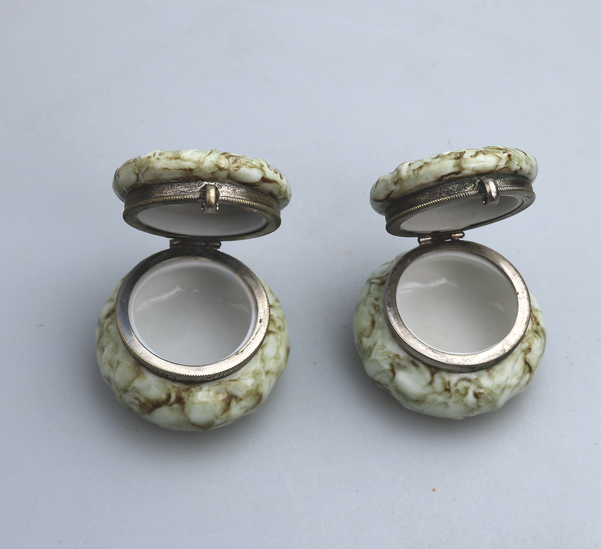 A pair of antique porcelain Continental cherub lidded Jars / Boxes C.19thC