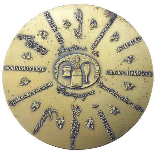 A bronze Advertiser for Champagne Academy Commemorative Disc Paperweight C.1982