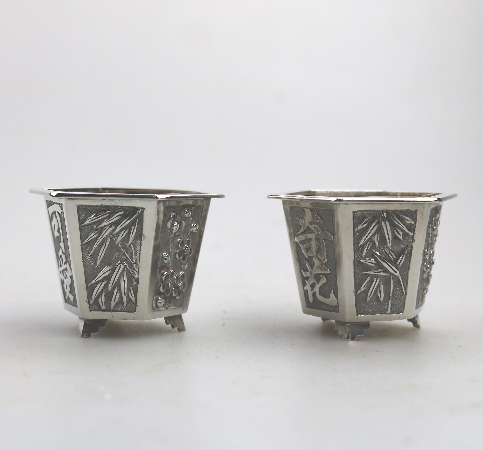 A good pair antique Chinese solid silver novelty Wang Hing Salts & liners C.1900
