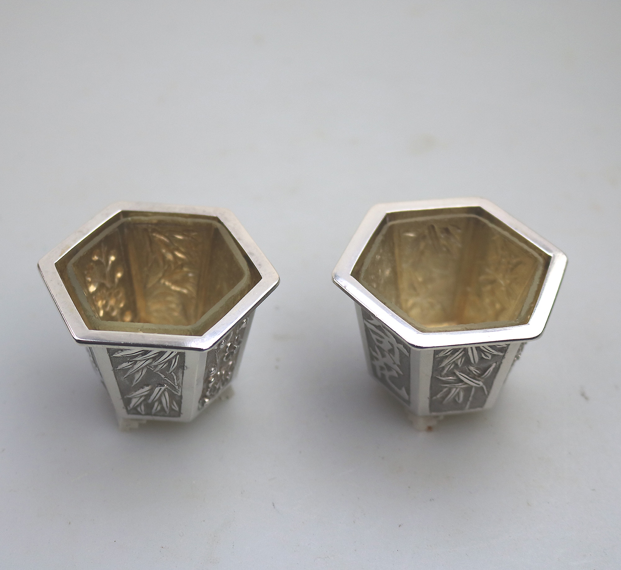 A good pair antique Chinese solid silver novelty Wang Hing Salts & liners C.1900