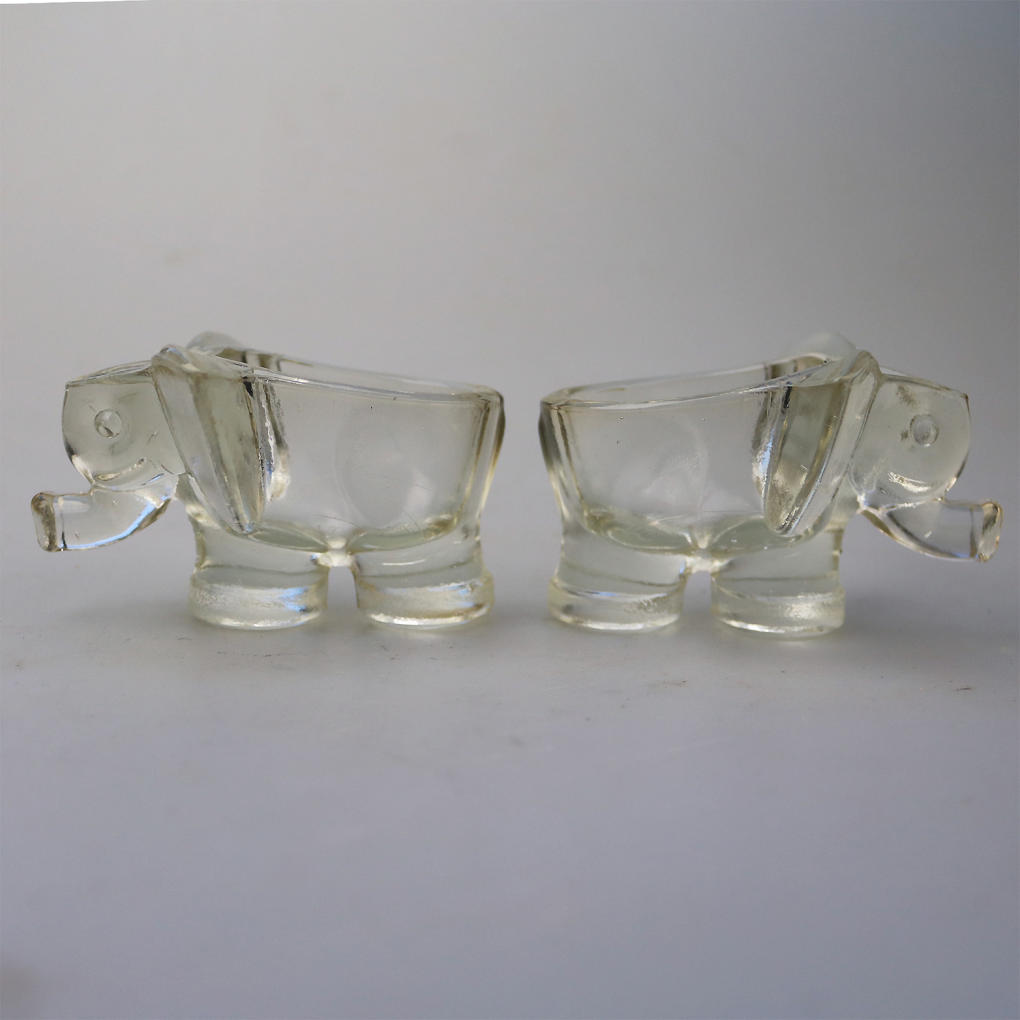 An unusual pair of Art Deco novelty elephant pressed glass Salt Cellars C.1920's