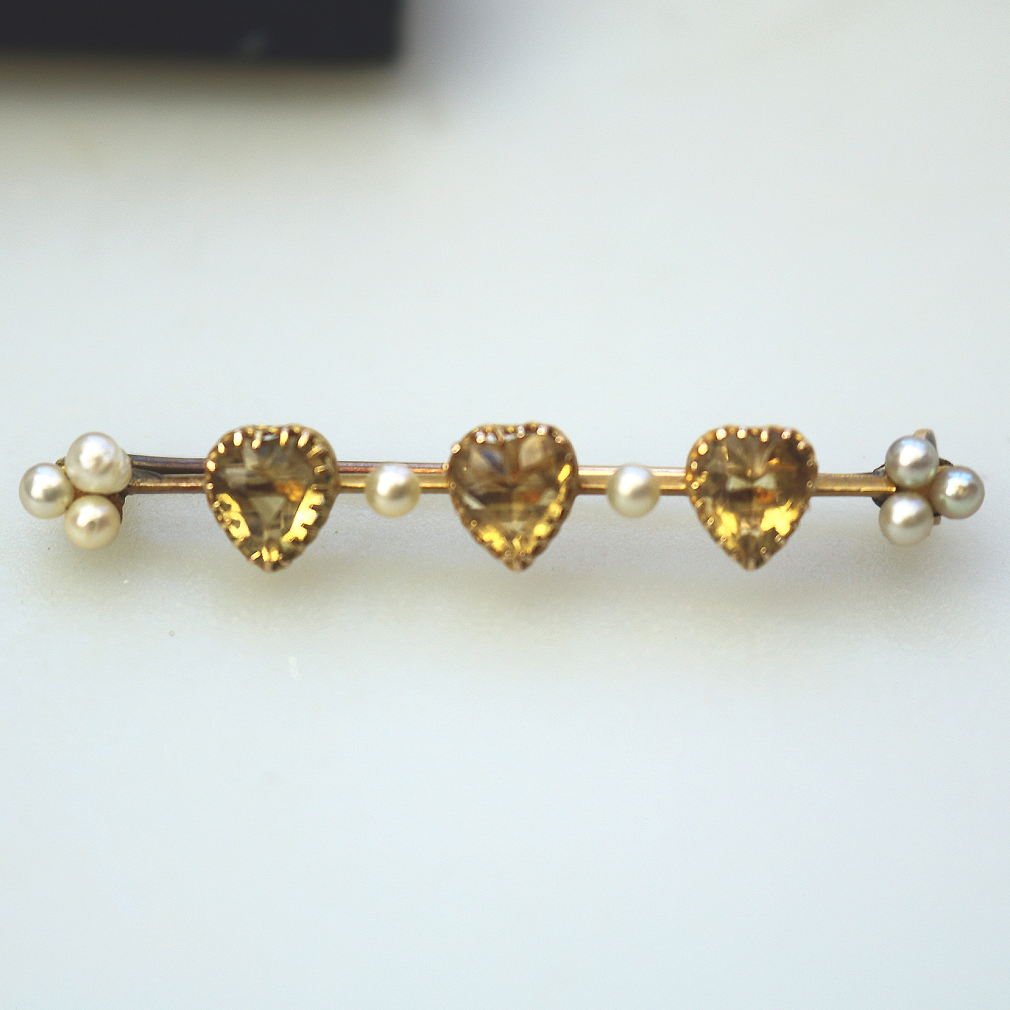A very fine antique 15ct gold bar brooch set 3X heart cut citrine or yellow topaz C.1900