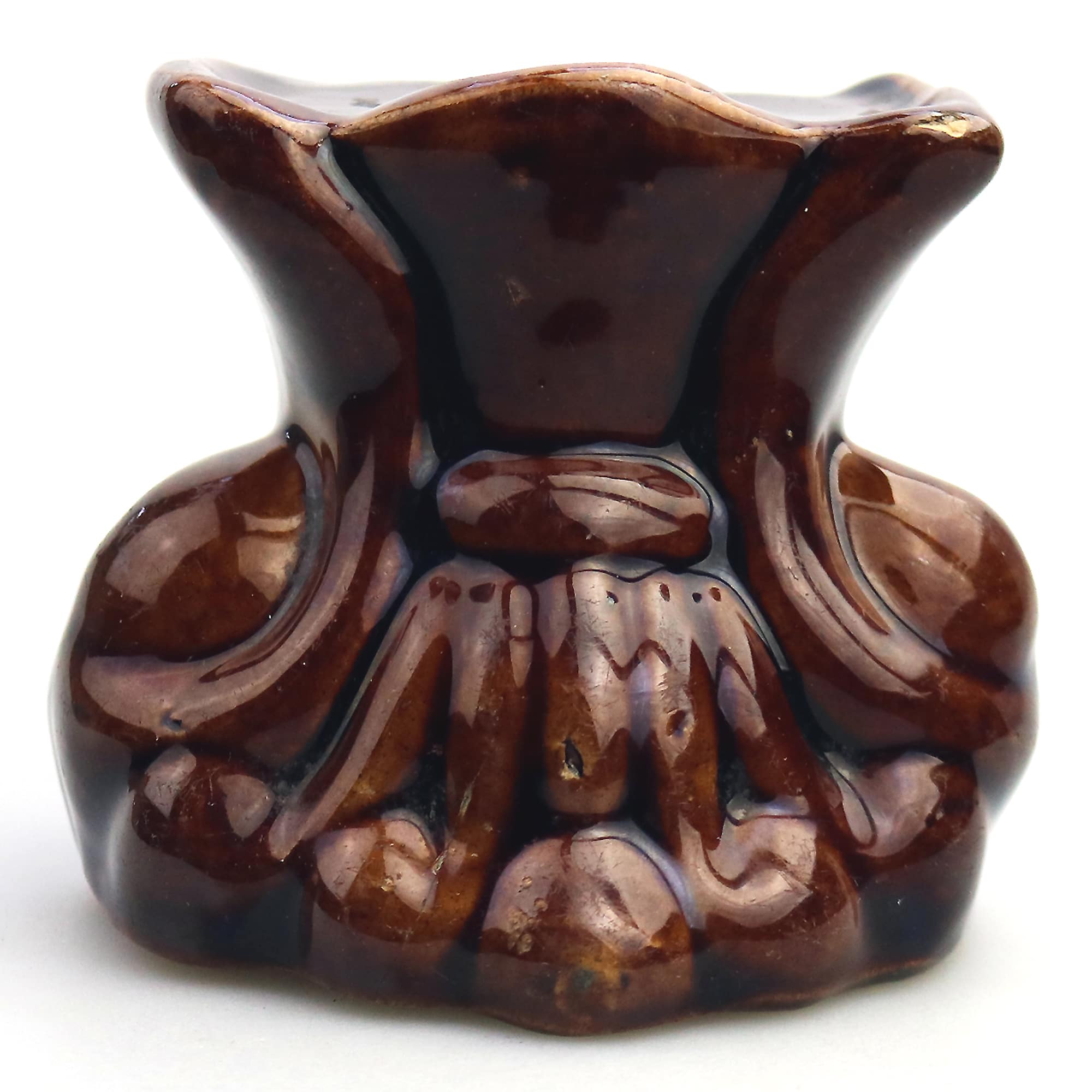 An antique Georgian Rockingham treacle pottery lion paw furniture support C.1825