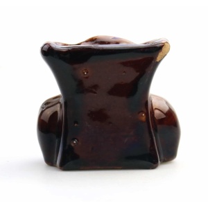 An antique Georgian Rockingham treacle pottery lion paw furniture support C.1825
