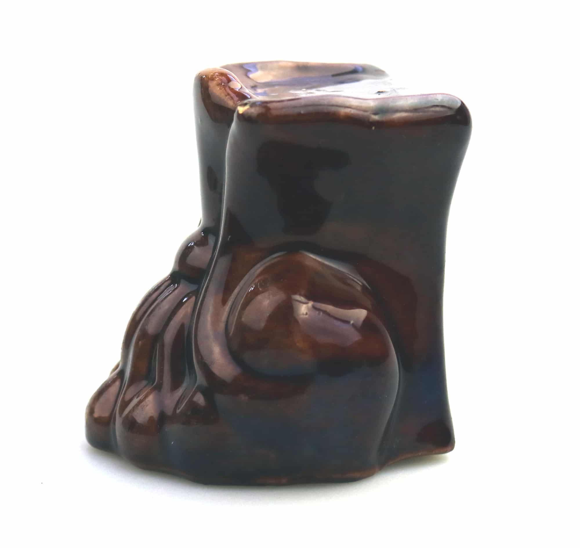 An antique Georgian Rockingham treacle pottery lion paw furniture support C.1825