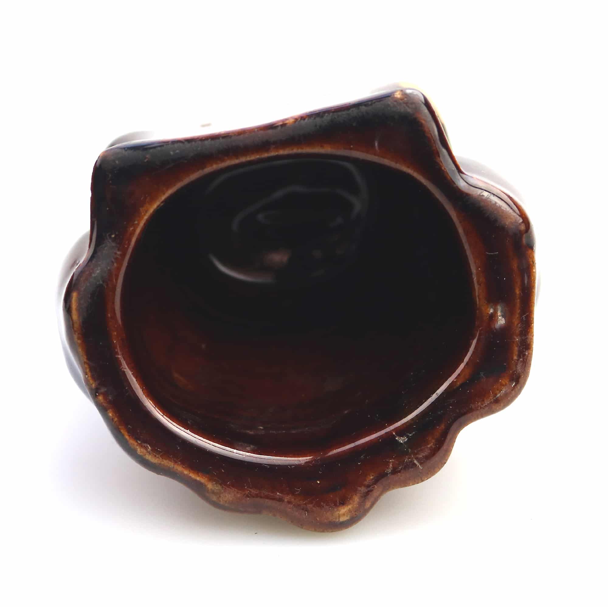 An antique Georgian Rockingham treacle pottery lion paw furniture support C.1825