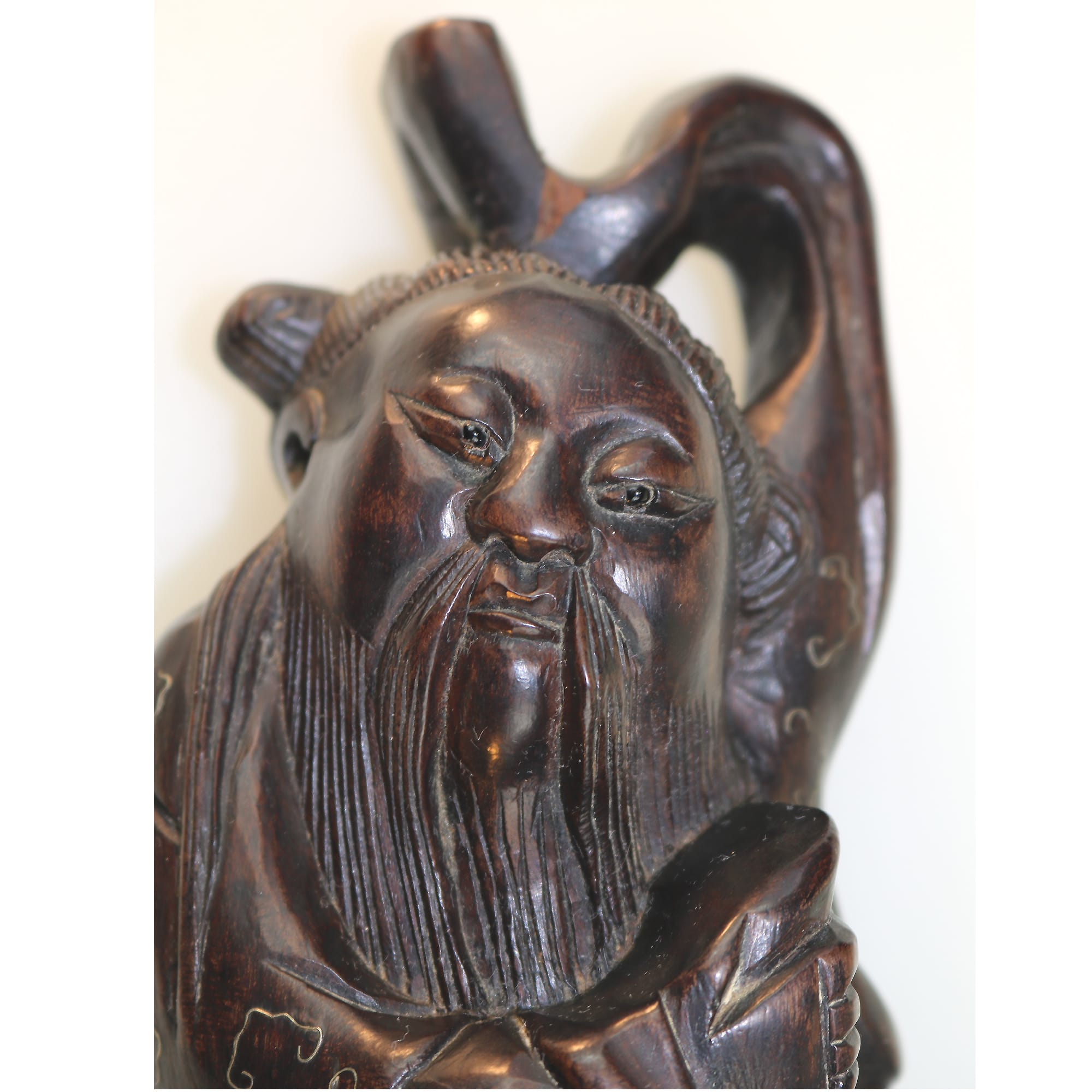 A large antique Chinese silver inlaid hardwood carved Figurine of a Sage C.19thC