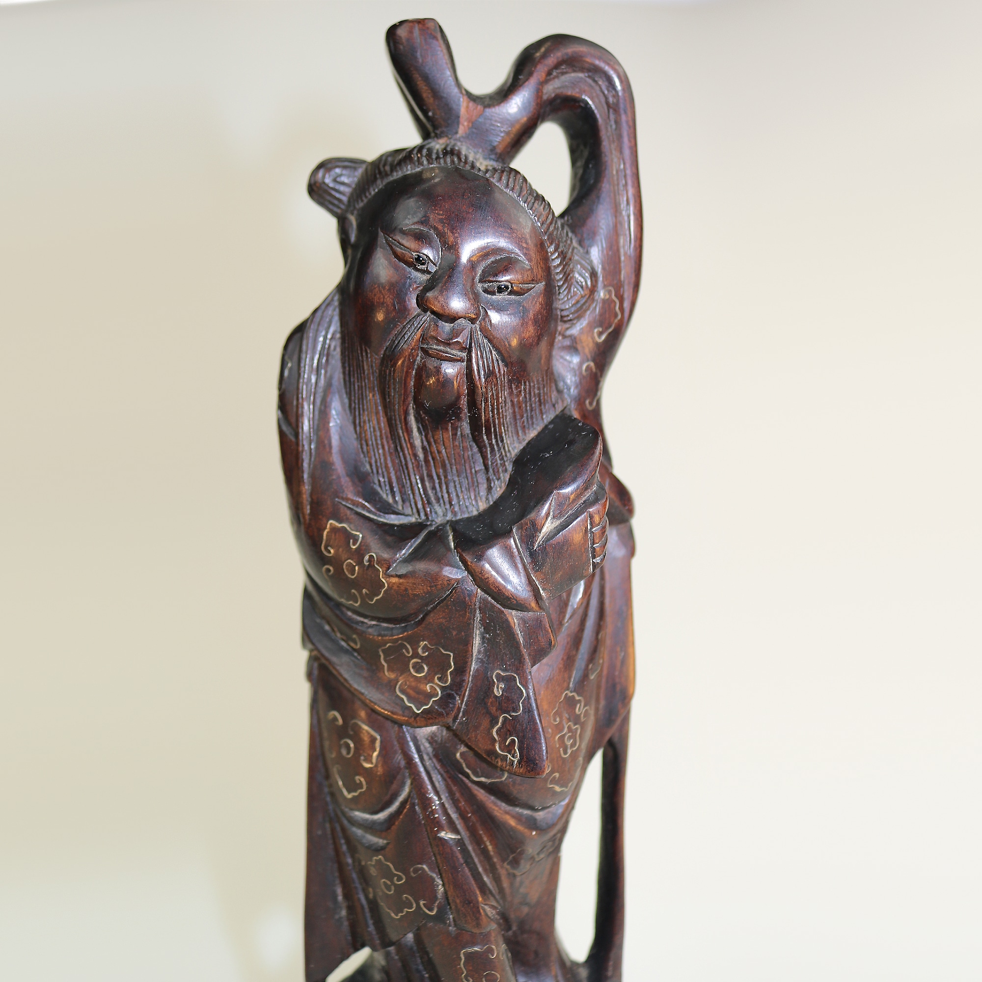 A large antique Chinese silver inlaid hardwood carved Figurine of a Sage C.19thC