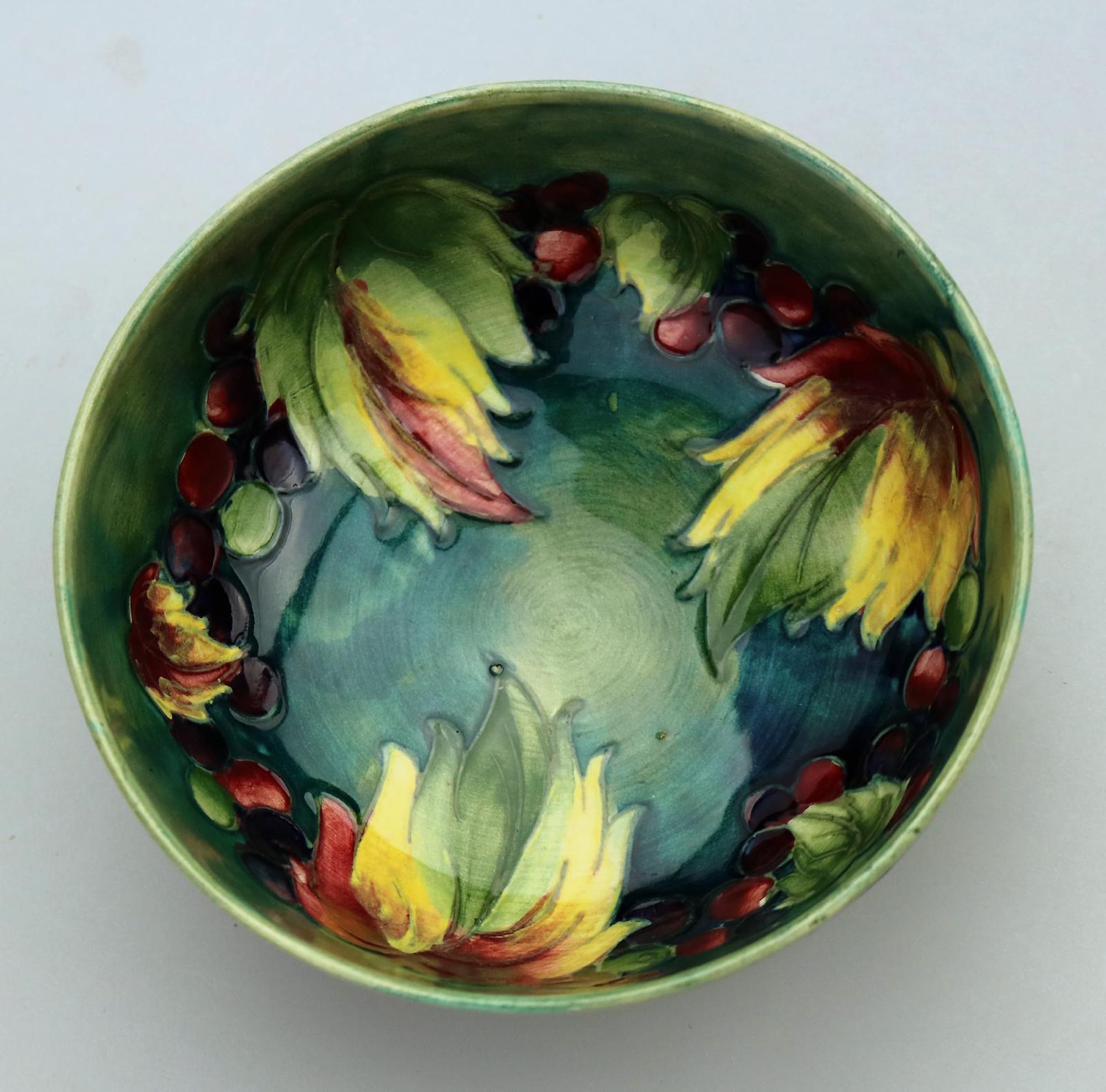 A good William Moorcroft antique British Art Pottery leaf & berry Bowl C.1928
