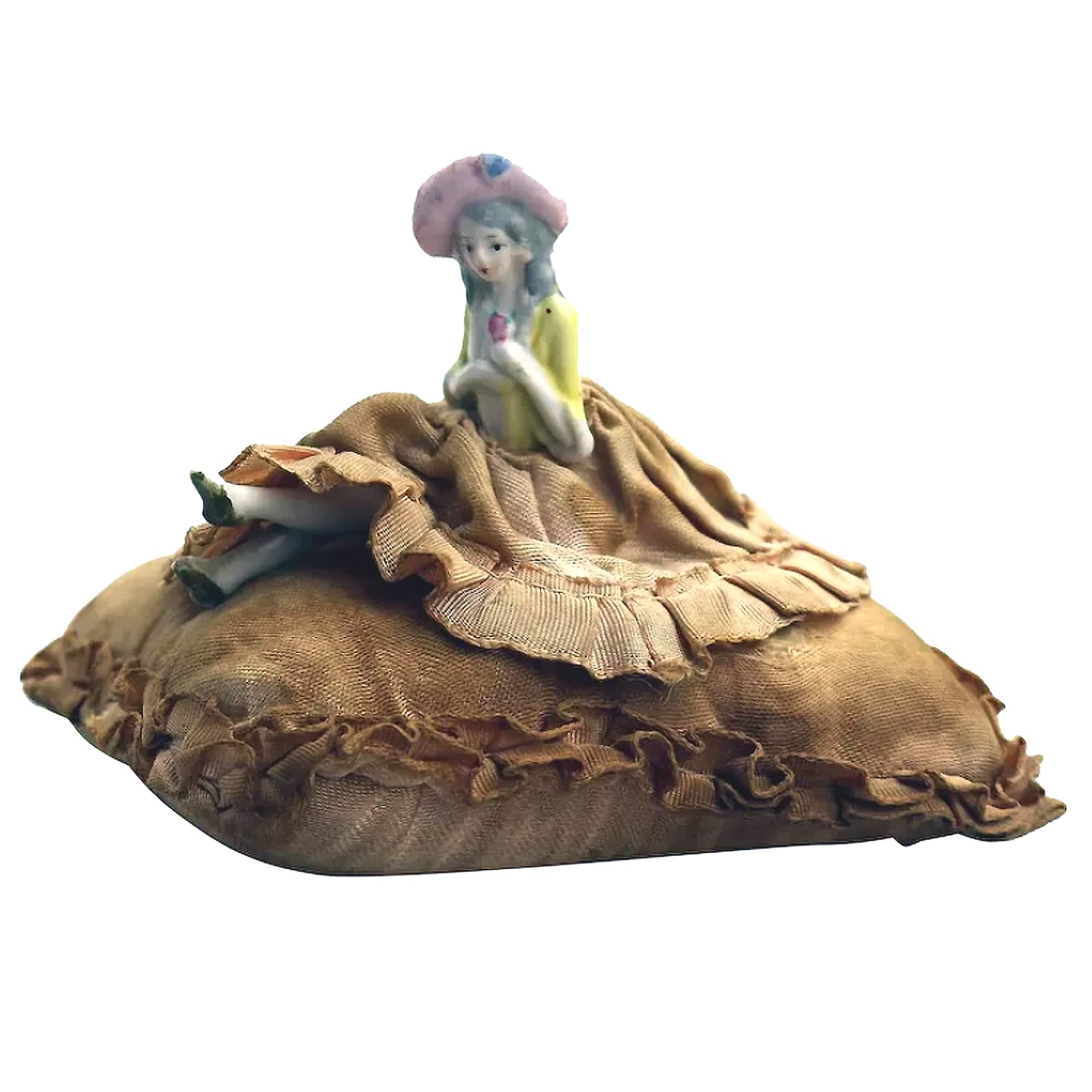 A good antique hand-painted porcelain half doll with legs on cushion C.early 20thC