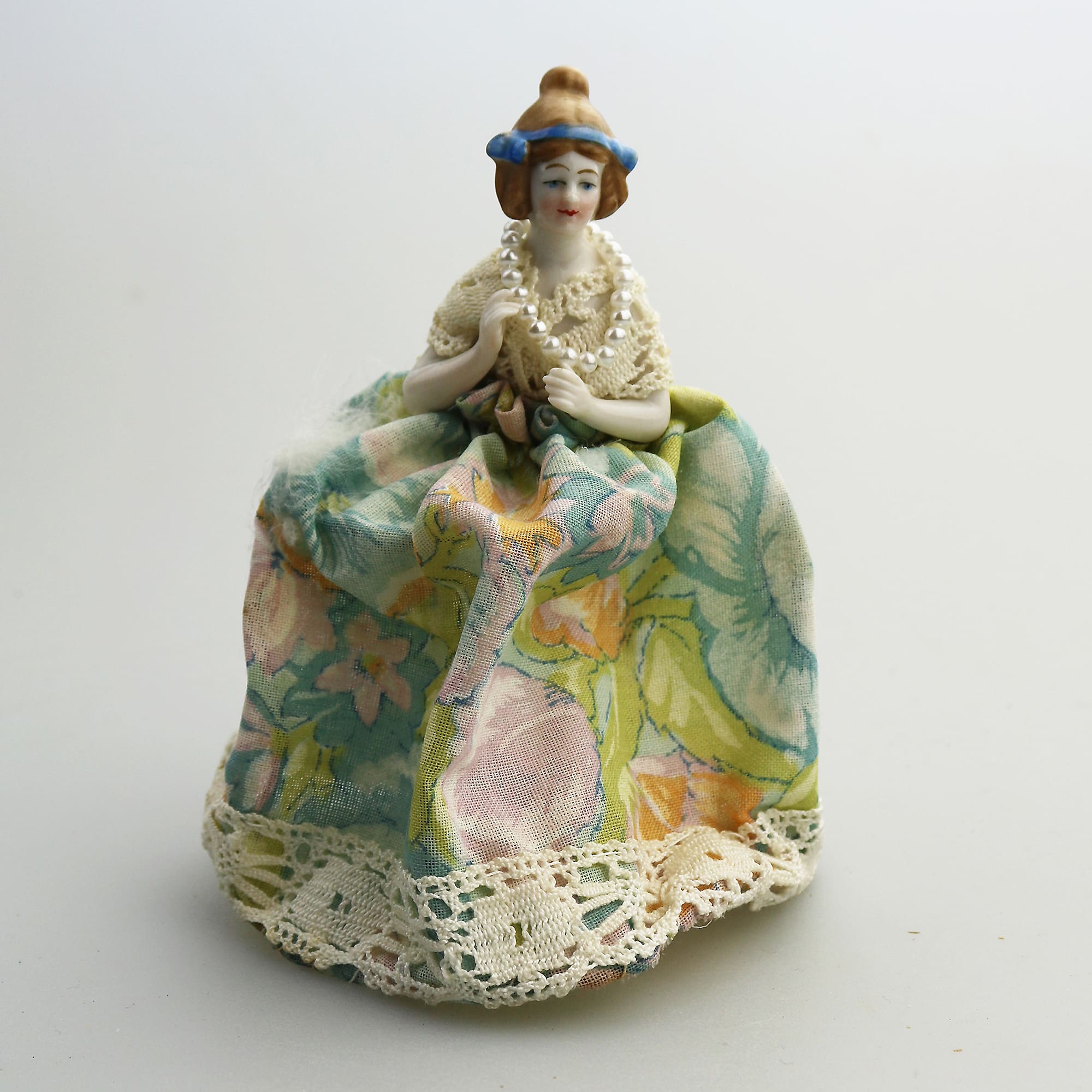 A good antique novelty porcelain half doll with dress - wire frame C.early 20thC