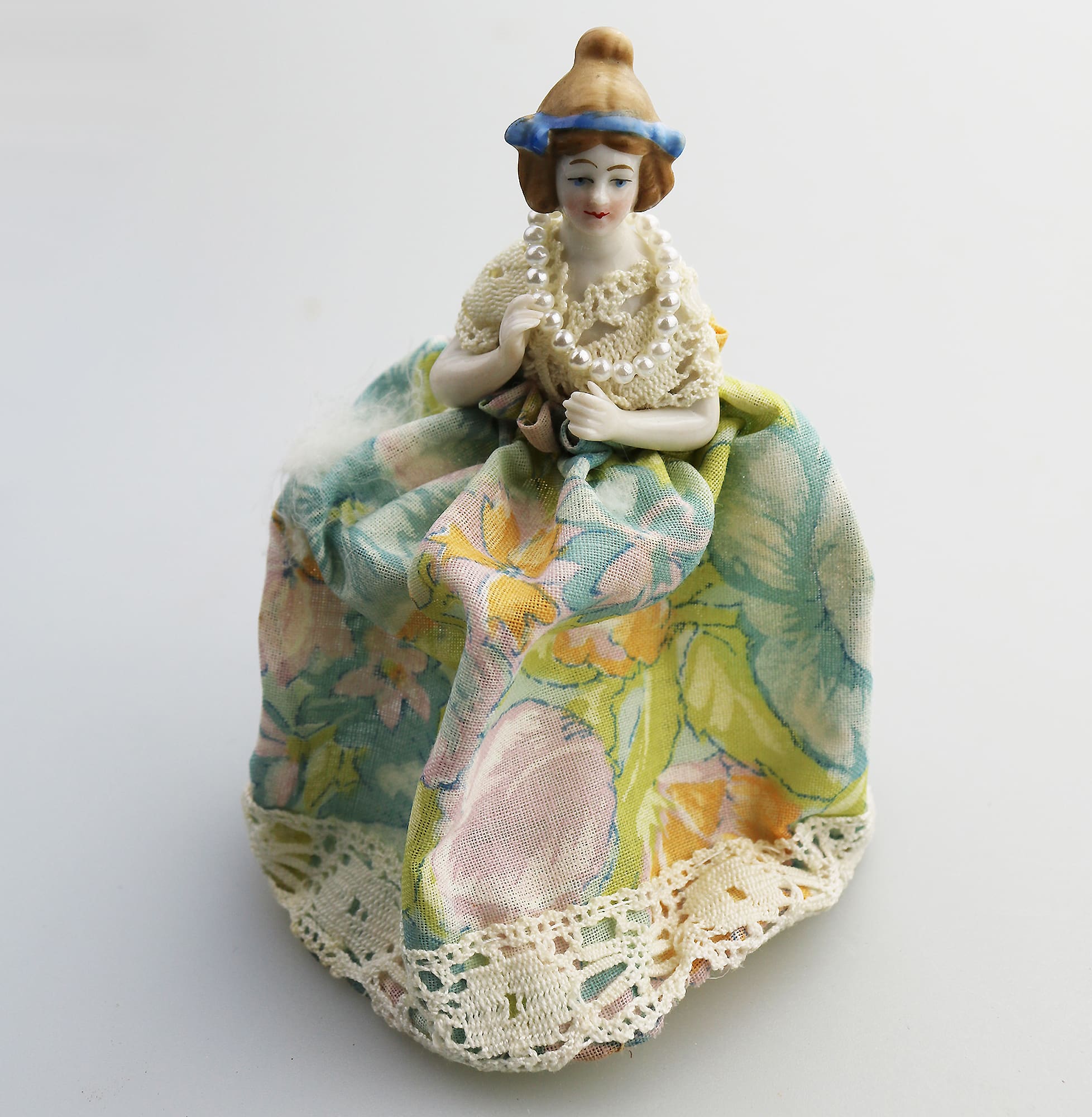 A good antique novelty porcelain half doll with dress - wire frame C.early 20thC