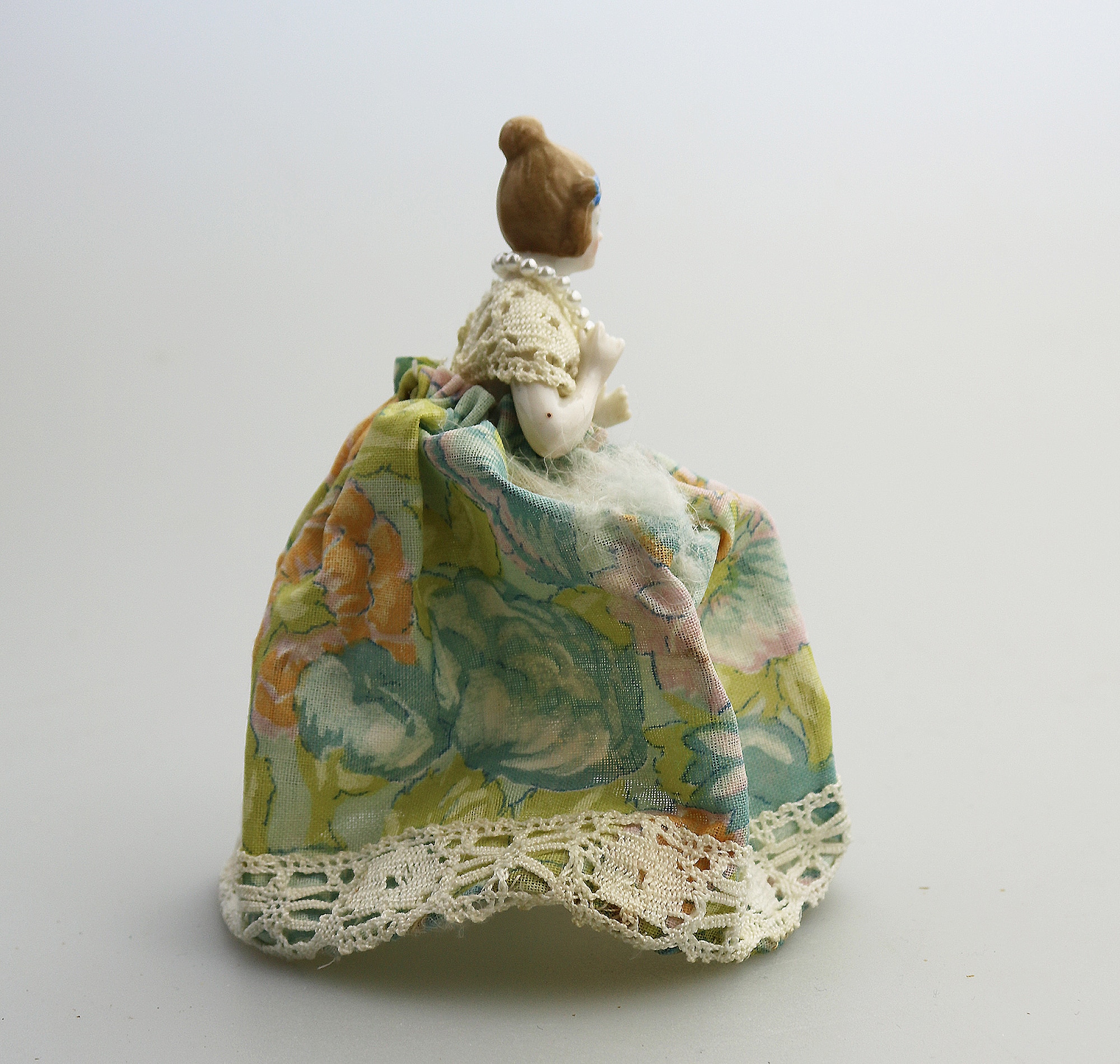 A good antique novelty porcelain half doll with dress - wire frame C.early 20thC